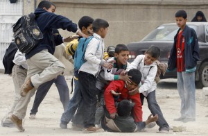 School boys fight in a street in front of their school in Baghdad's Sadr city